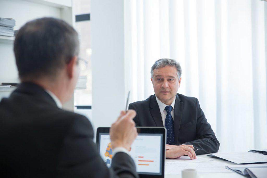 Business professionals in a focused discussion during an office meeting.